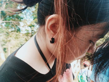 Close-up of young woman looking down