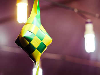 Low angle view of illuminated lamp against blurred background