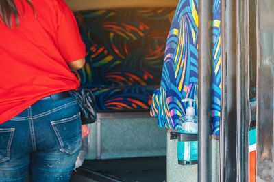 Rear view of woman holding multi colored umbrella