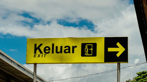 Low angle view of road sign against sky