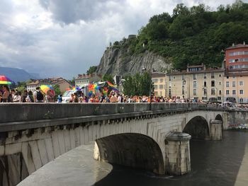 Bridge over river against buildings