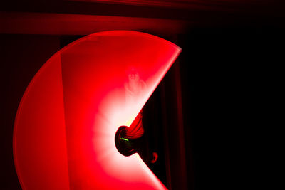 Close-up of illuminated lamp against black background