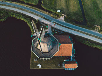Aerial view of windmill over lake by road