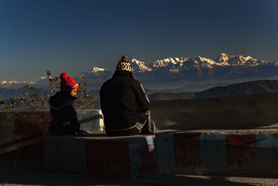 Rear view of man standing against mountain