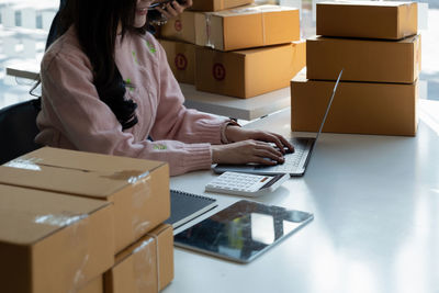 Midsection of woman working at office