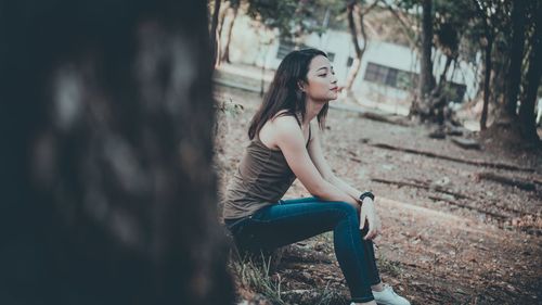 Portrait of young woman sitting outdoors