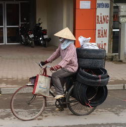 Man riding bicycle on street in city