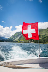 Close-up of flag against blue sea