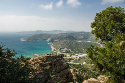 High angle view of sea and trees against sky