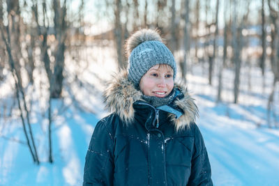 Portrait of smiling woman in snow