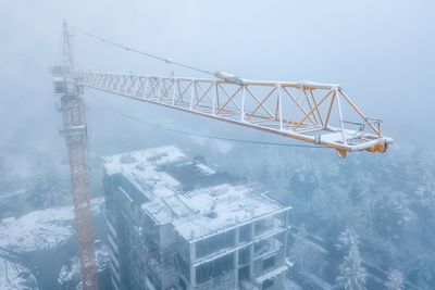 Crane over building in city during winter