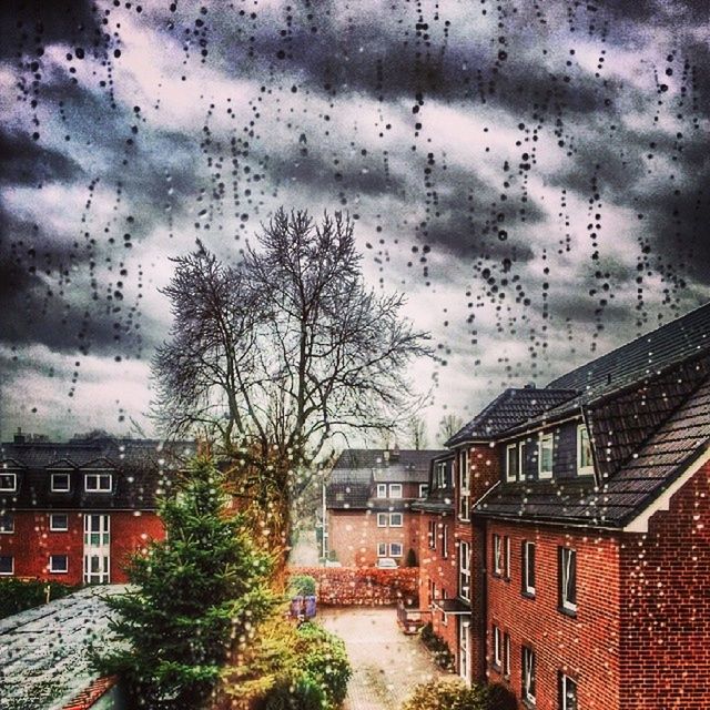 architecture, building exterior, built structure, window, weather, sky, tree, wet, rain, house, season, transportation, residential structure, glass - material, cloud - sky, overcast, residential building, building, day, city