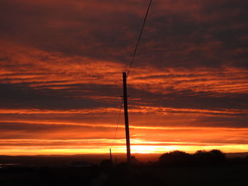 Silhouette trees against sky during sunset