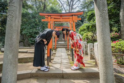 Rear view of people outside temple