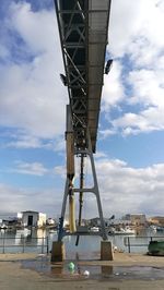Low angle view of cranes against sky