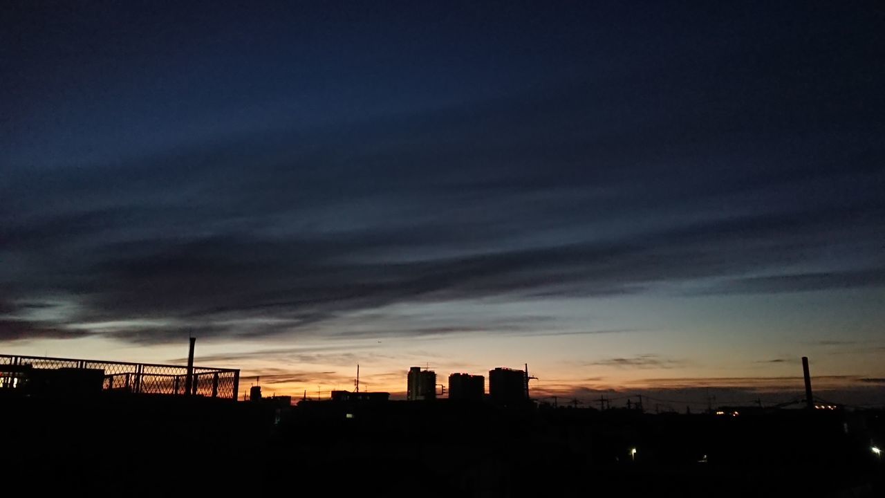 SILHOUETTE BUILDINGS AGAINST DRAMATIC SKY
