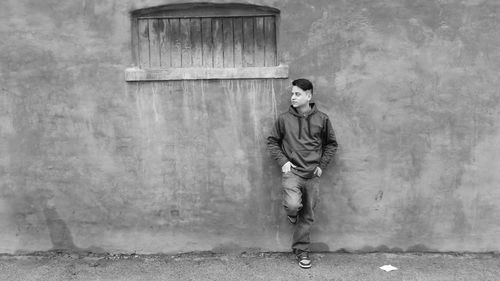 Full length of woman standing by railing