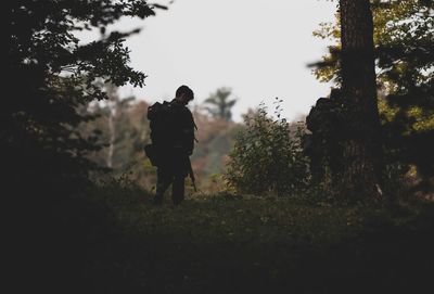 Rear view of man walking on field