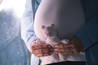 Midsection of baby boy holding toy