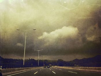 View of road against cloudy sky