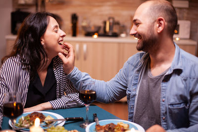 Side view of young woman sitting at restaurant