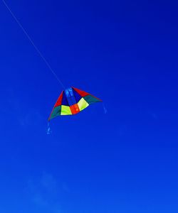 Low angle view of colorful kite against sky