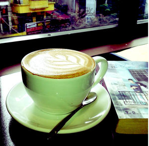 Close-up of cappuccino served on table