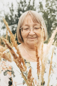 Portrait of woman against plants