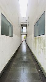 Rear view of people walking on street amidst buildings
