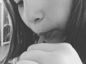 Close-up of girl drinking drink with straw