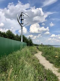 Street light on field against sky