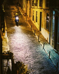 Rear view of man walking in canal