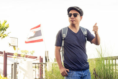 Portrait of young man standing at beach