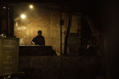 Man working in factory at night