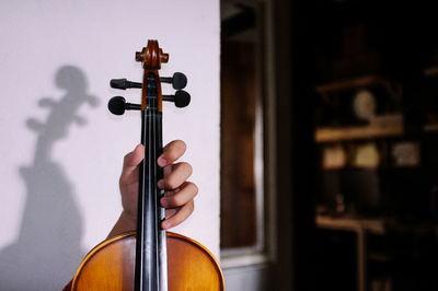 Close up view of man holding a violin