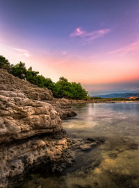 Scenic view of sea against sky at sunset