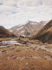 Scenic view of mountains against cloudy sky