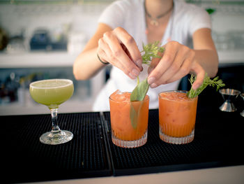 Close-up of bartender serving drinks at bar counter