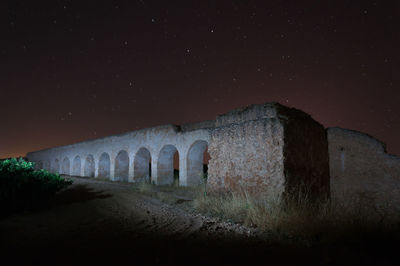 Old building against sky at night