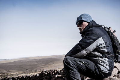 Man looking away against clear sky