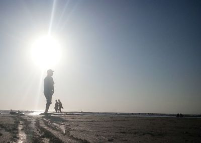Silhouette man standing on land against clear sky