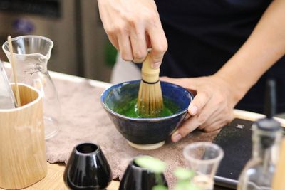 Midsection of person preparing food on table