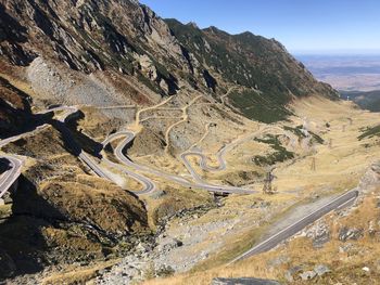 High angle view of road by mountains against sky