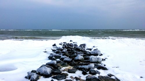 Scenic view of sea against sky during winter