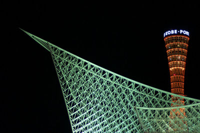 Low angle view of illuminated tower against sky at night