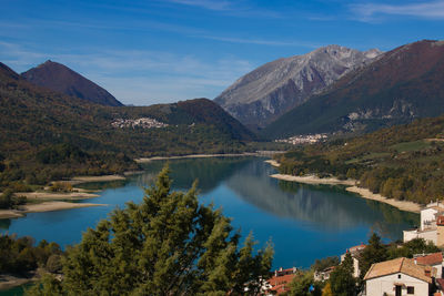 Scenic view of lake and mountains against sky