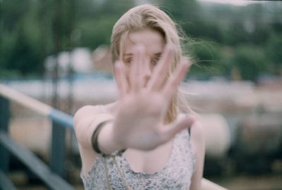 Close-up of young woman with hand