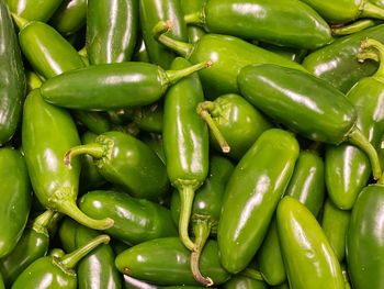 Full frame shot of green chili peppers for sale in market