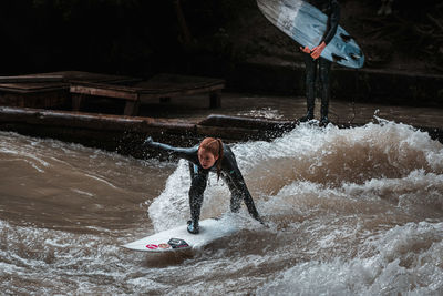 Full length of man splashing water