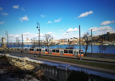 Train on railroad tracks in city against sky